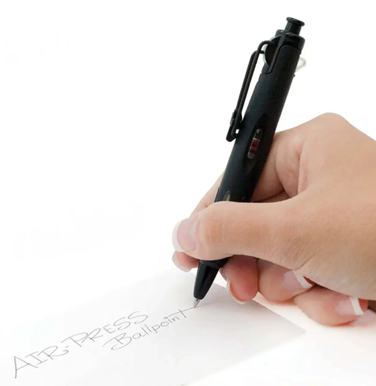 Hand holding a black pen writing on paper with 'AIR TAPES' branding.